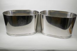 A pair of oval plated champagne coolers engraved with aphorisms from Lily Bollinger and Napoleon,