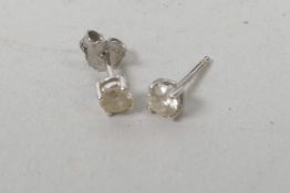 A pair of white gold set diamond stud earrings