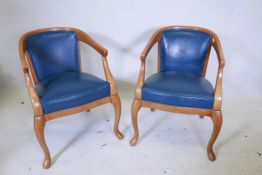 A pair of contemporary horseshoe back open armchairs with leatherette seats and backs, raised on