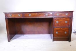 A contemporary mahogany desk, with three drawers over two, 64" x 25" x 30"