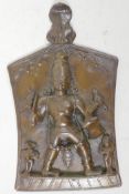 An Indian bronze wall plaque depicting a four armed warrior deity, 8" high