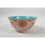 A Chinese polychrome porcelain rice bowl with coral red lotus flower decoration, seal mark to