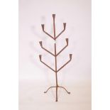 A wrought iron seven branch floor standing candlestick, 47" high