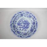 A Chinese blue and white porcelain charger with a lobed rim, the centre decorated with a dragon