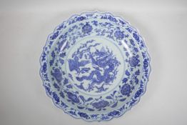 A Chinese blue and white porcelain charger with a lobed rim, the centre decorated with a dragon