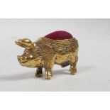A brass pincushion in the form of a pig, 1½" long