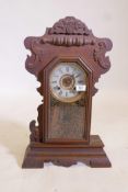 An American 'Gingerbread' mantel clock by the New haven Clock Co. with silvered chapter ring and