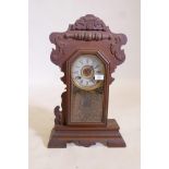 An American 'Gingerbread' mantel clock by the New haven Clock Co. with silvered chapter ring and