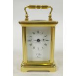 A miniature French L'Epee eight day carriage clock in polished brass and bevelled glass, eleven