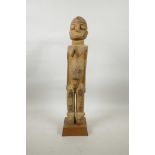 An early C20th carved wood fertility figure of a female nude, 20" high