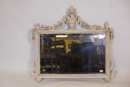 A painted wood overmantel mirror with carved floral swag and urn decoration