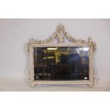 A painted wood overmantel mirror with carved floral swag and urn decoration