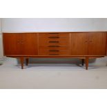 A Norwegian Gustav Bahus mid century teak sideboard with four doors and five drawers, probably by