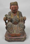 A Chinese painted wooden figure of a dignitary wearing fine robes with wired decoration, seated on a