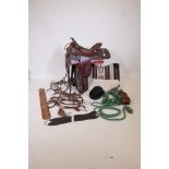 A tooled leather Western saddle by Bona Allen with leather stirrups, fleece lined, comes with