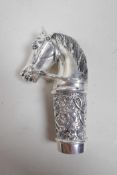 A white metal cane handle in the form of a horse's head, stamped 800, 3½"