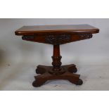 A William IV mahogany card table on a carved and turned column, platform base and four scrolled