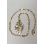 A stylish three stone 9ct gold pendant with central sapphire and two white stones, on a delicate