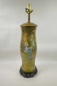 A reverse decorated glass lamp on a hardwood stand, decorated with birds and butterflies, 23" high