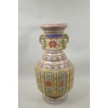A Chinese polychrome enamelled porcelain two handled vase with panel decorated with asiatic flowers,