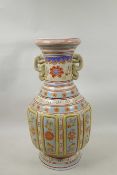 A Chinese polychrome enamelled porcelain two handled vase with panel decorated with asiatic flowers,