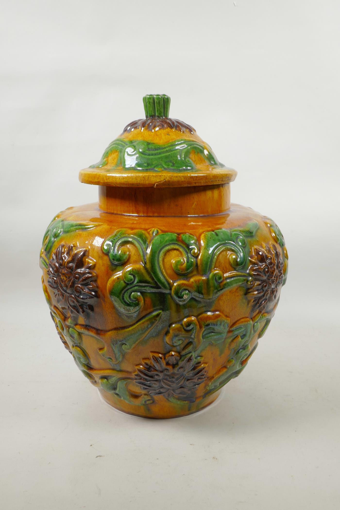 A large Chinese Sancai glazed pottery jar and cover with raised scrolling lotus flower decoration, - Image 2 of 6