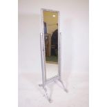 An ornate silver painted rectangular cheval dressing mirror, 61" high