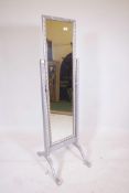 An ornate silver painted rectangular cheval dressing mirror, 61" high