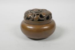 A Chinese bronze censer and cover, with pierced peach tree decoration, impressed mark to base, 4"