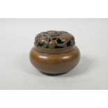 A Chinese bronze censer and cover, with pierced peach tree decoration, impressed mark to base, 4"