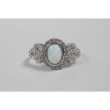 A silver, cubic zirconium and opalite panelled ring, approximate size 'P'