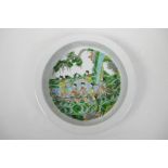 A Chinese famille verte porcelain dish decorated with women on a raft, 4 character mark to base, 8½"