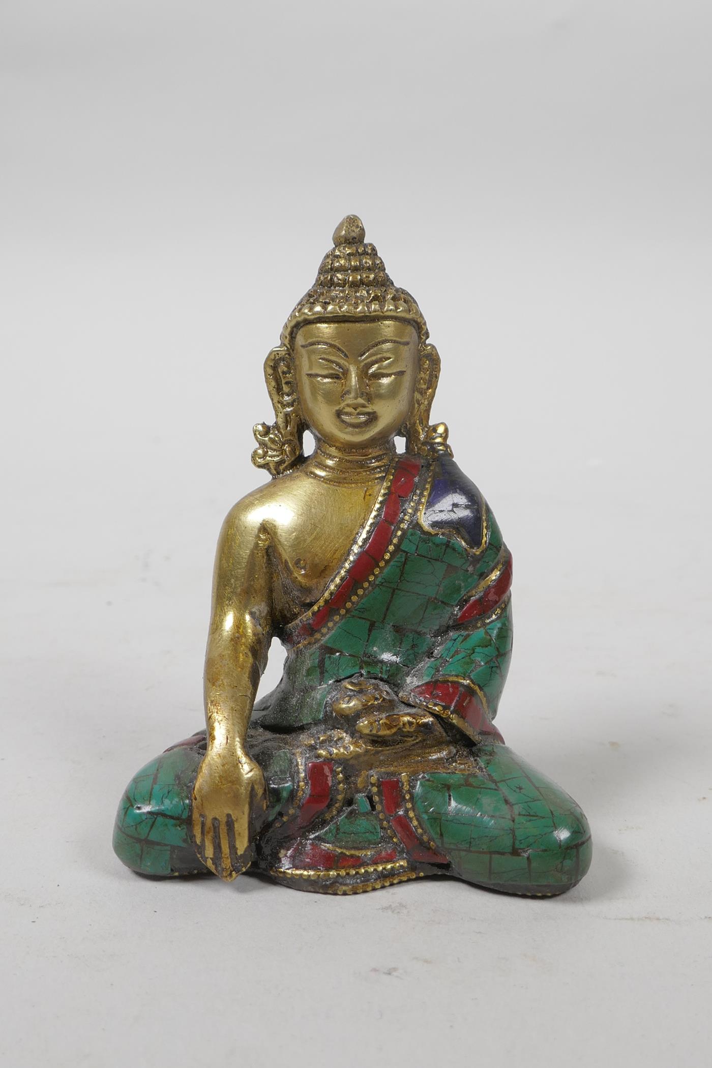 A Tibetan brass Buddha with a stone inset robe, 3" high