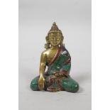 A Tibetan brass Buddha with a stone inset robe, 3" high
