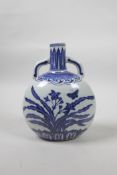 A Chinese blue and white porcelain two handled moon flask decorated with butterflies and flowers,