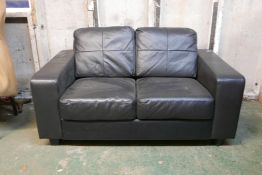 A leather two seat sofa, 59" wide