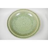 A large Chinese celadon glazed charger with embossed pheasant decoration, 16" diameter