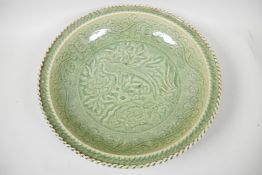 A large Chinese celadon glazed charger with embossed pheasant decoration, 16" diameter