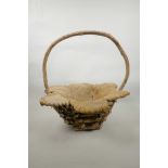 A wood and coconut husk petal shaped basket, 18" high