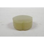 A Chinese celadon jade petal shaped pot and cover, 2" diameter