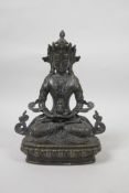 A Sino-Tibetan bronzed metal figure of Buddha seated in meditation on a lotus throne, 9" high