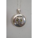 A 925 silver locket and chain, decorated with an owl's head, 1½" drop