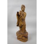 A Chinese carved hardwood figure of a musician, A/F lacks flute, 15" high