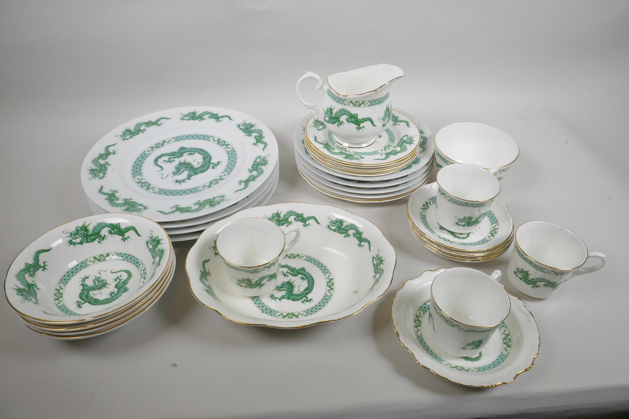 A Newcastle on Tyne China four place setting dragon pattern dinner and tea service