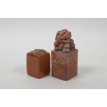 A Chinese red soapstone seal with carved kylin decoration, and another amber soapstone seal with