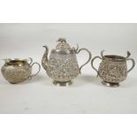 A beautiful C19th Anglo-Indian solid silver (tested) tea service, comprising teapot, cream jug and