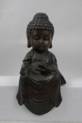 A Chinese bronze mount in the form of a big head Buddha, 10" high