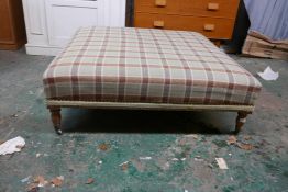 A large footstool, with brass stud decoration, raised on turned oak supports, 48" x 48" x 16"