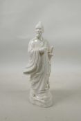 A blanc de chine robed figure carrying a sword, 9½" high