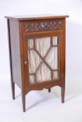 A Victorian walnut music cabinet with single drawer, the front with carved Gothic tracery over